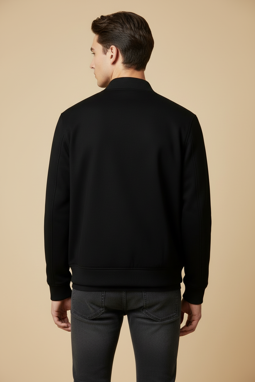 Back view of model wearing black bomber jacket