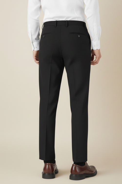 Back view of model wearing black dress pants