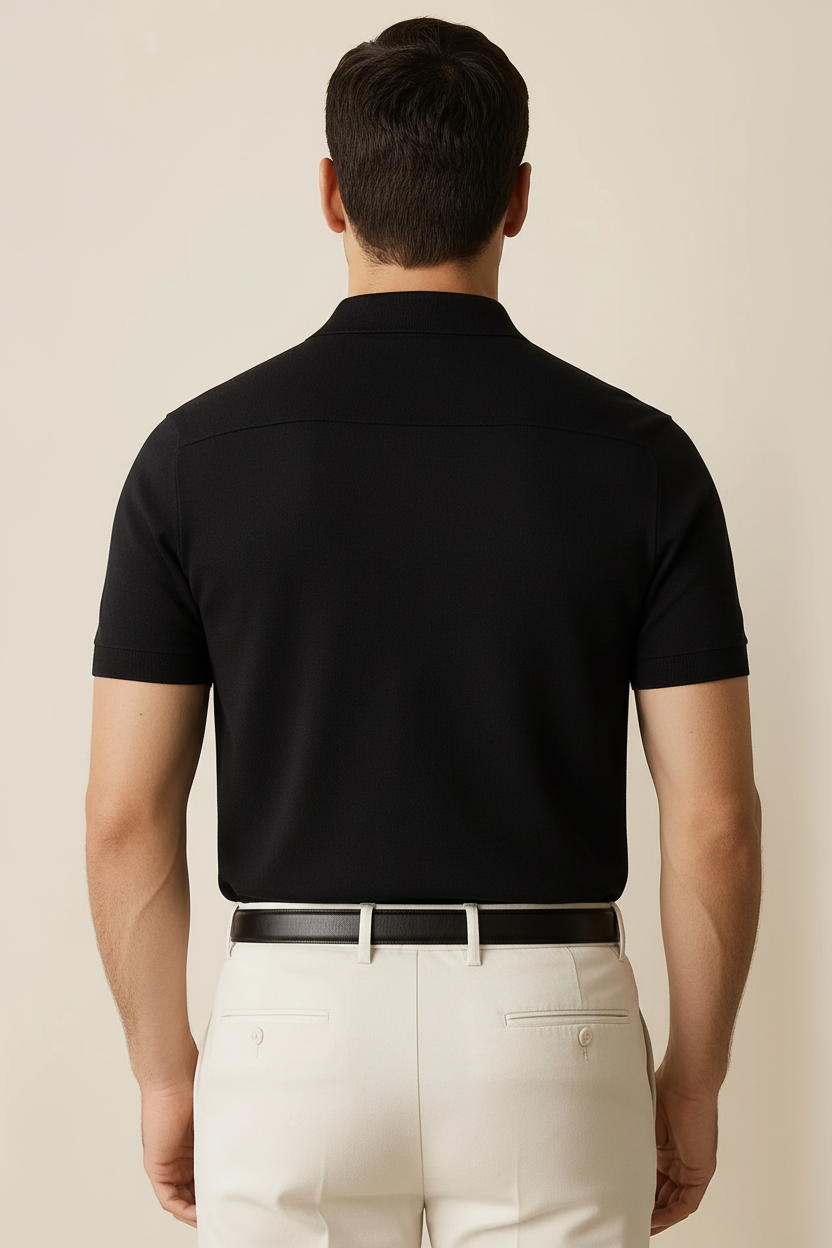 Back view of model with arm hair wearing black polo